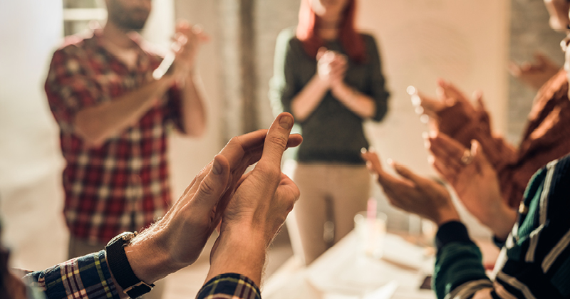 A group of people clapping