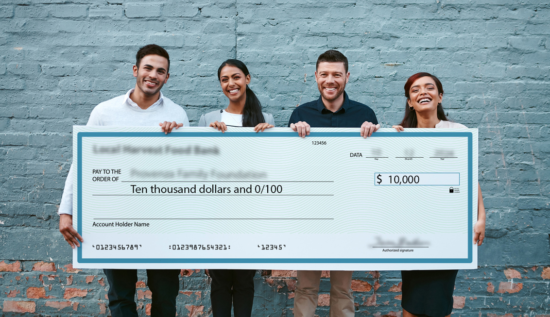 Foundations people holding a large check